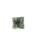 Square-shaped green gemstone on a light gray background
