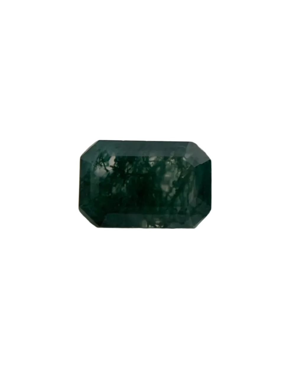 Faceted green gemstone on a textured surface